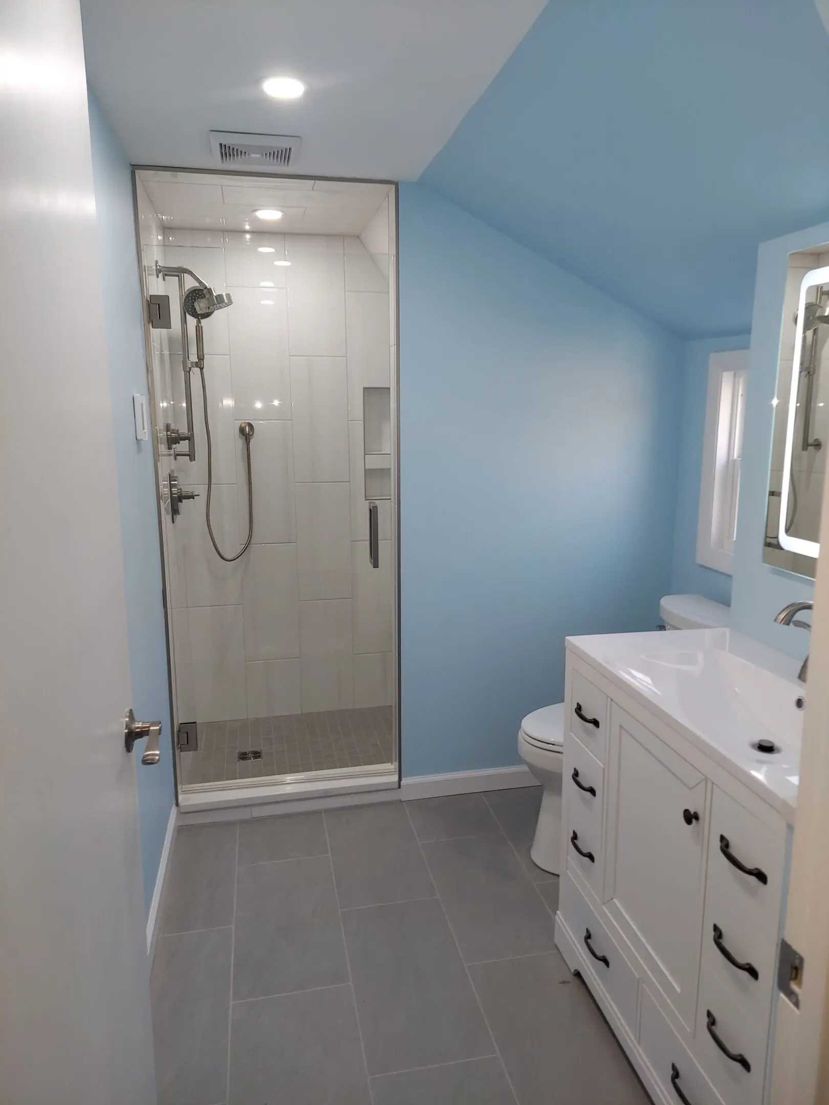 Modern bathroom with shower and vanity.