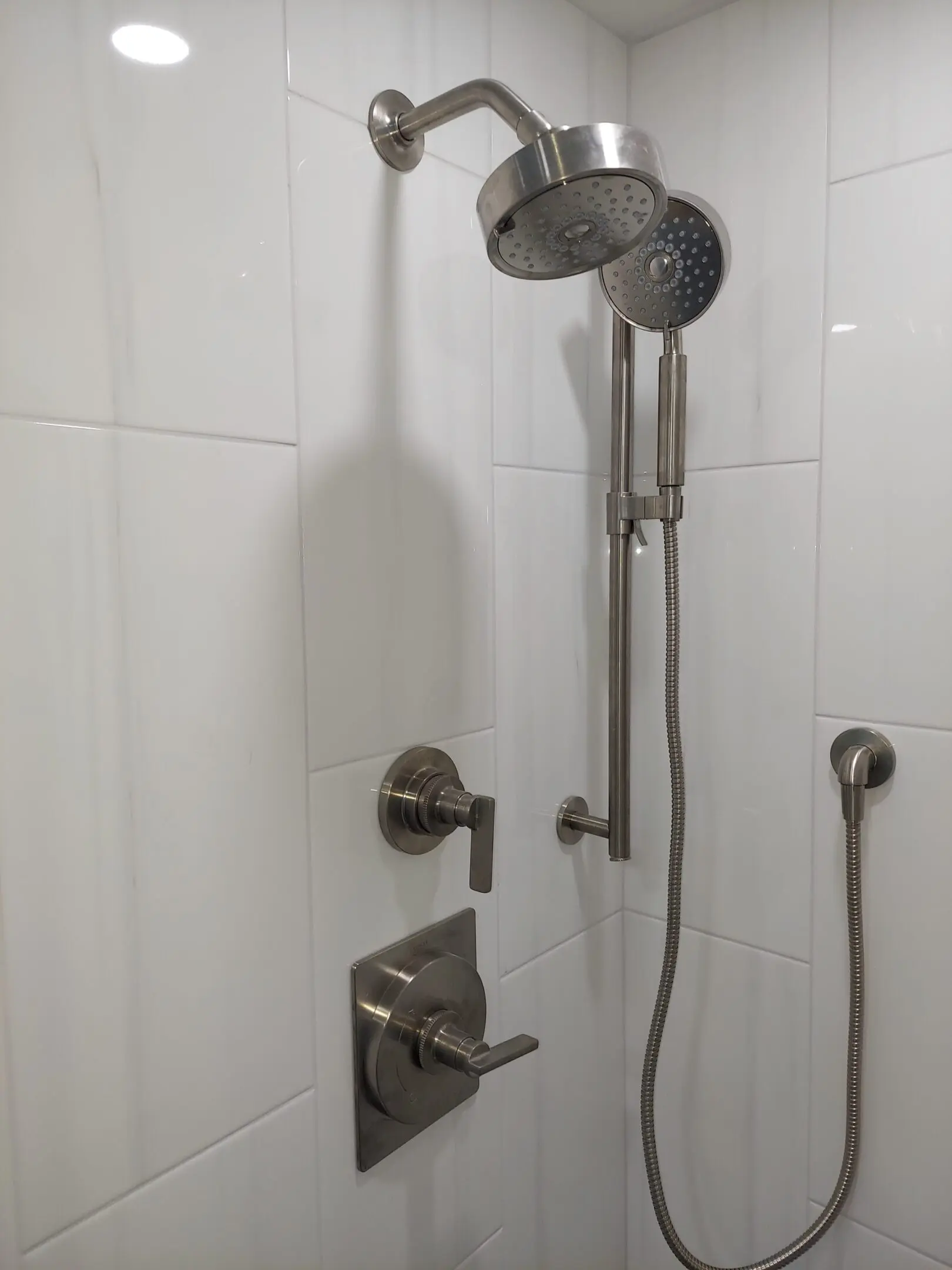 Modern shower with dual showerheads and controls.